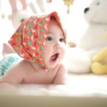 toddler wearing head scarf in bed